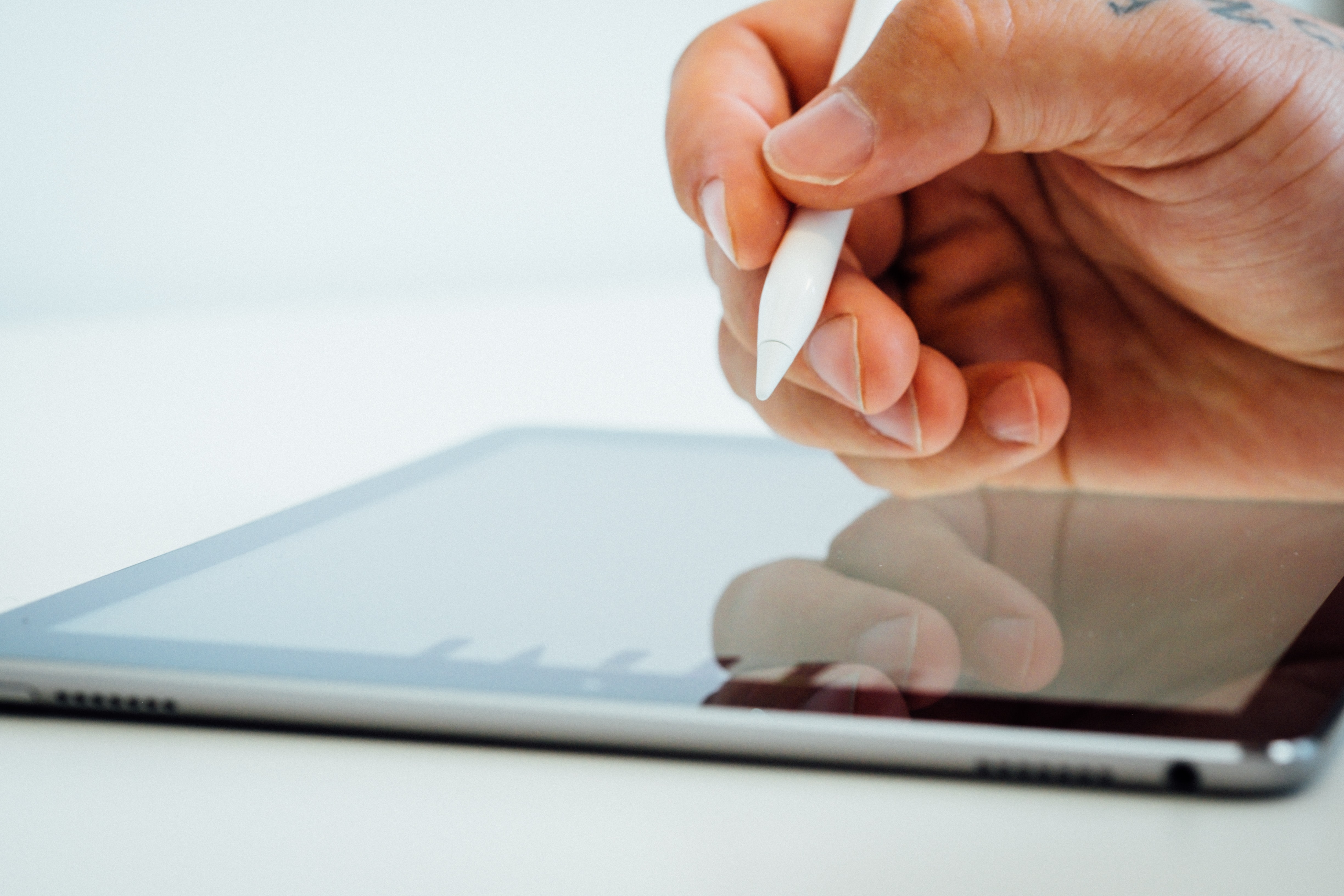 Closeup of hand writing on tablet with a stylus