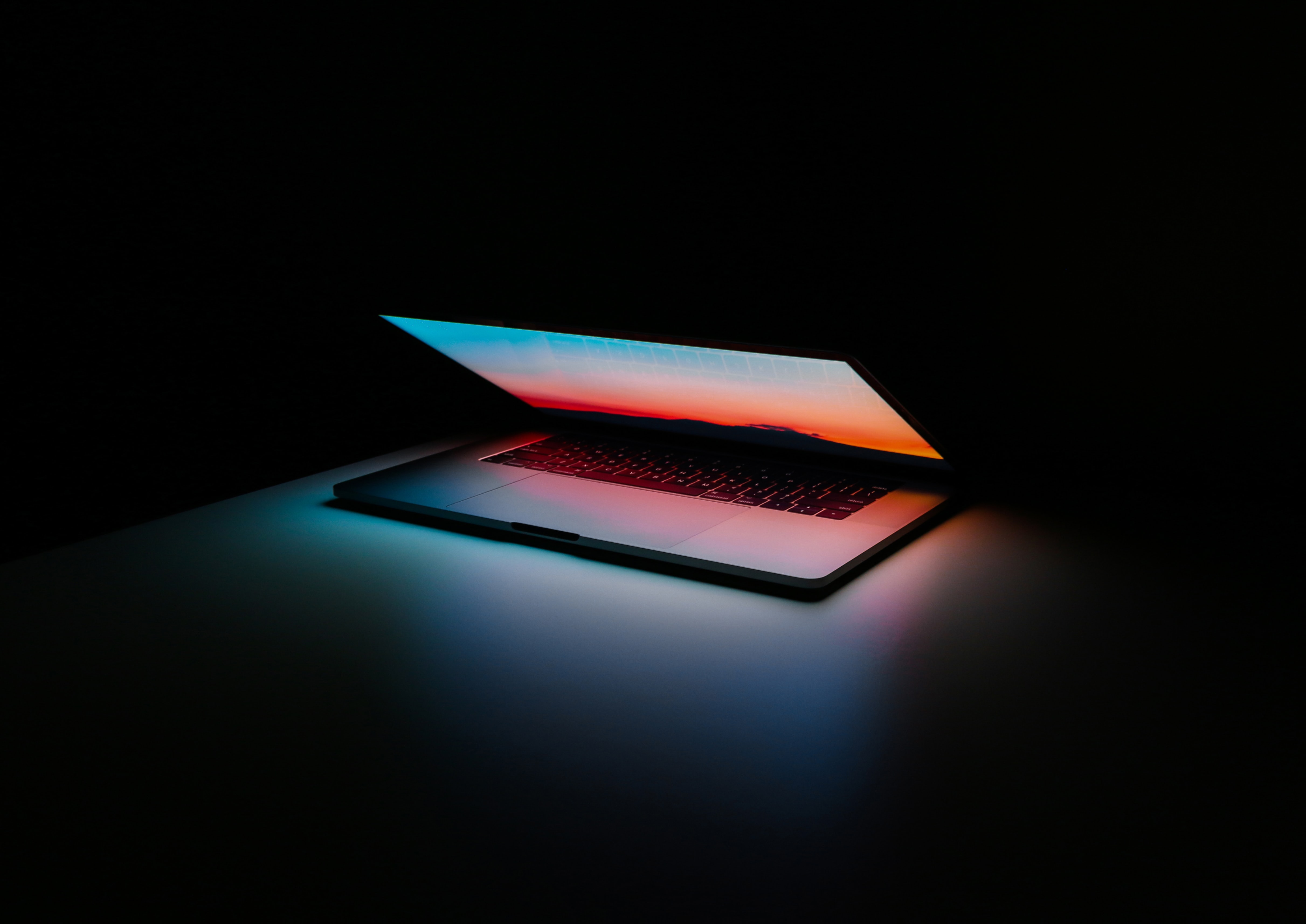half opened laptop in a dark room