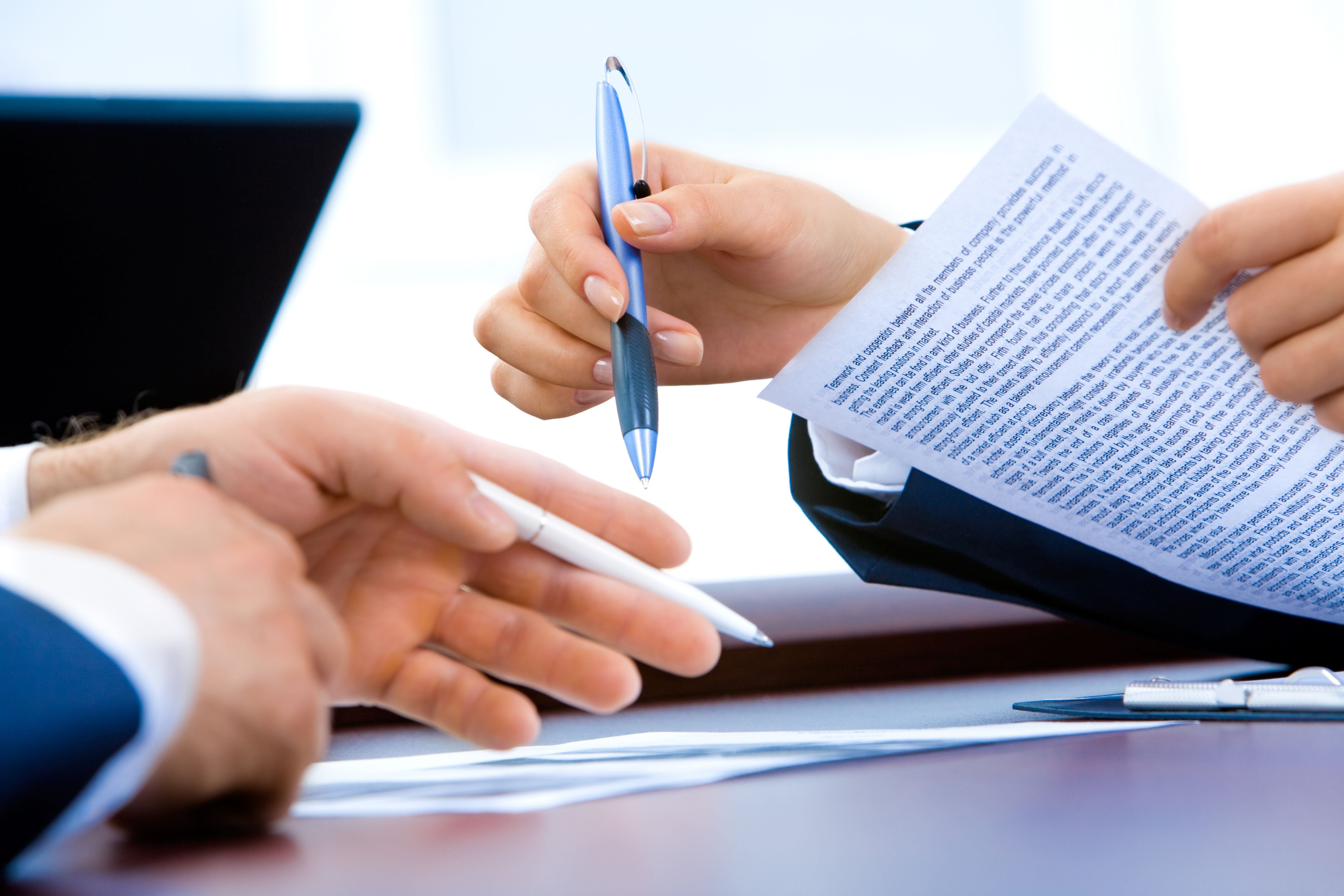 close up on hands writing on documents