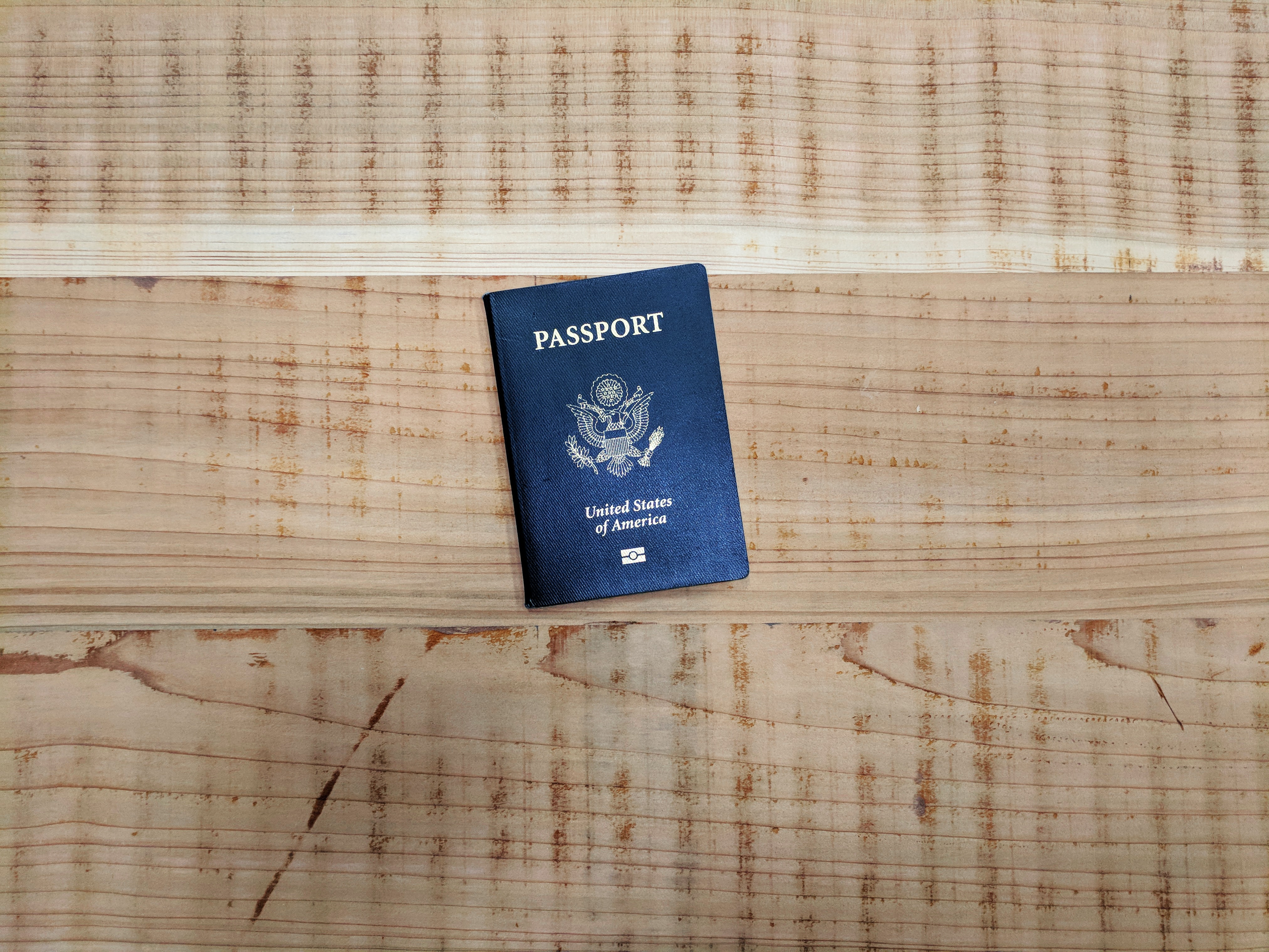 blue united states passport on wooden background