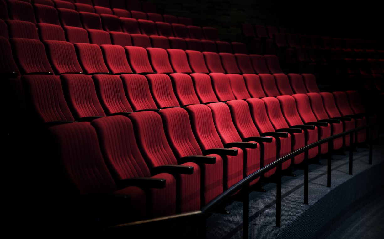 rows of empty red theatre seats dimly lit by stage lights beg the question: Will tax policy and incentives help fuel the arts and culture in ireland?