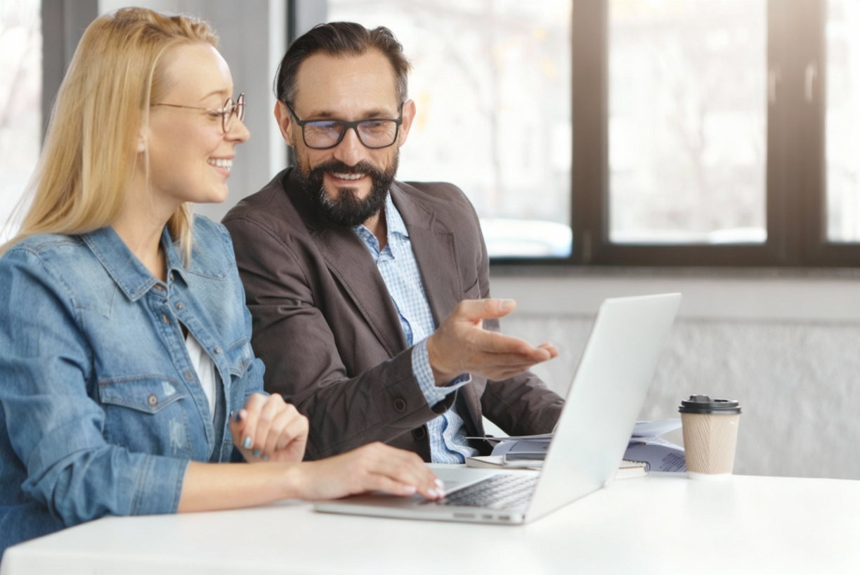 two accountants gesture at a laptop screen